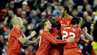 Raheem Sterling, centre top, is congratulated by his team-mates after scoring Liverpool's equaliser against Chelsea in the League Cup semi-final first leg at Anfield. Peter Powel/EPA