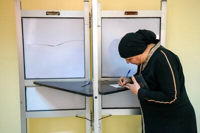 A woman marks her ballot at a polling station in Shubra. Dana Smillie for The National