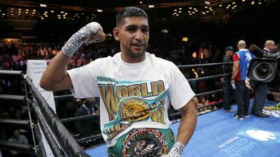 Amir Khan celebrates after defeating Chris Algieri via a unanimous points decision at the Brooklyn Center. Julio Cortez / AP Photo / May 29, 2015