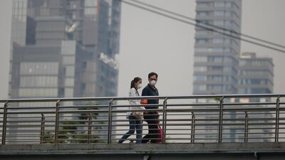 People wear face masks as heavy air pollution continues to affect Bangkok. EPA
