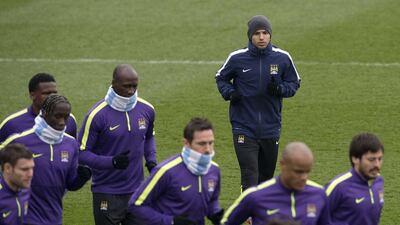 The Manchester City squad take a group jog. Oli Scarff / AFP