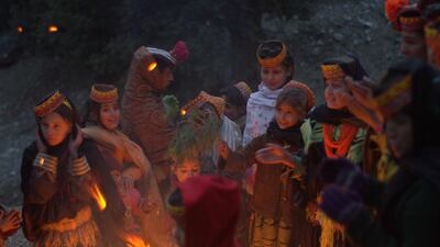 Kalasha children gather around the bonfire on the eve of the Choimus winter festival. The Kalasha are an indigenous people who live in the valleys close to Afghanistan and practice a religion that has elements of paganism, animism, and Hinduism. Mobeen Ansari
