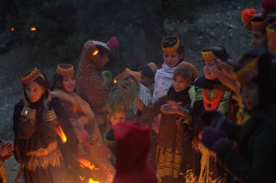 Kalasha children gather around the bonfire on the eve of the Choimus winter festival. The Kalasha are an indigenous people who live in the valleys close to Afghanistan and practice a religion that has elements of paganism, animism, and Hinduism. Mobeen Ansari