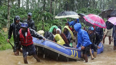 Indian army soldiers and volunteers transport flood victims to safer areas in Kodagu dictrict, in the southern Indian state of Karnataka. Flash floods and mudslides caused by days of torrential rains in the southern Indian states of Kerala and Karnataka have forced hundreds of thousands to move to relief camps. AP Photo