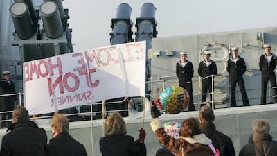 Family members wave to loved ones aboard HMS Richmond as she returns home to Portsmouth. Getty Images