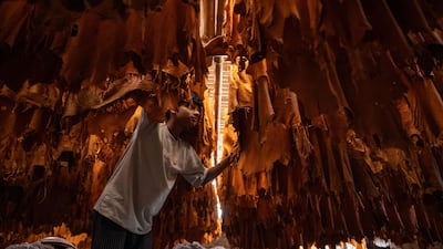 A Bangladeshi labourer inspects leather at a tannery in Dhaka. AFP
