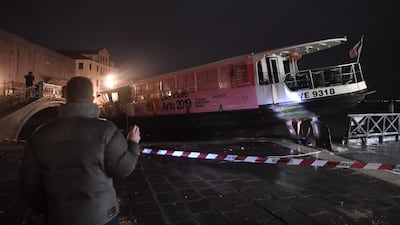 A stranded taxi boat detached from its mooring and pushed over an embankment. AFP