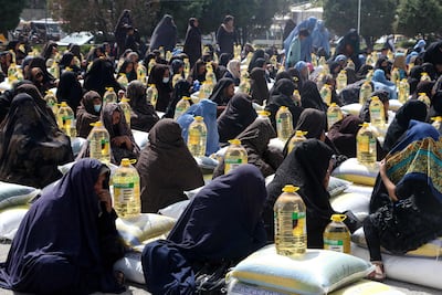 Women receive food aid distributed by a charity foundation in Herat, Afghanistan. AFP
