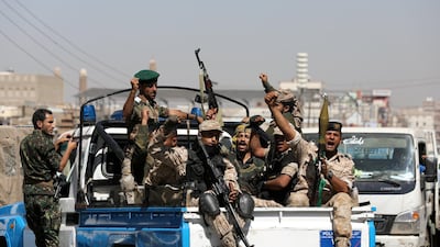 Houthi fighters ride on the back of a police patrol truck in Sanaa. Reuters