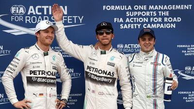 Lewis Hamilton, centre, will start at the front of the Australian GP grid alongside Mercedes teammate Nico Rosberg, left. Williams driver Felipe Massa starts third. William West / AFP