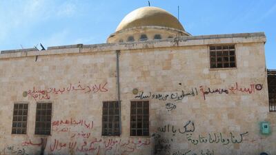 Graffiti is written on the exterior of a mosque in Al Eis after Syrian rebels and the Al Qaeda-affiliated Nusra Front took control of the town, in Aleppo countryside. Ammar Abdullah / Reuters