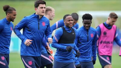 England's Raheem Sterling, centre, alongside Harry Maguire, left, and Bakayo Saka. PA
