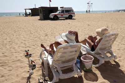 Relaxing on the beach in Tyre in southern Lebanon, amid ongoing cross-border exchanges between Hezbollah and Israel. AFP
