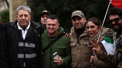 British far-right activist Tommy Robinson, second left, poses with anti-Iranian regime protesters in London. AFP