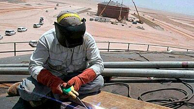 An Iraqi welder at work on an oil storage tank near Karbala. The spot price of a barrel of Brent Crude rose for the fifth day.