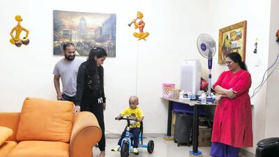 Aarev Shetty, 2, with his dad, Sushant Shetty, mom, Anu Rai, (L) and grandmother, Shakuntala. The child is back home from the hospital after receiving his cancer treatment. Reem Mohammed / The National