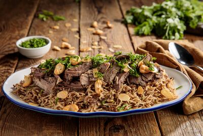 Lamb ouzi comes garnished with nuts. iStockphoto