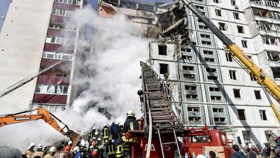 Rescue workers at a residential building hit by a Russian missile in Uman, central Ukraine. EPA
