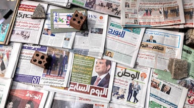 Newspapers laid out at a newsstand Cairo. AFP