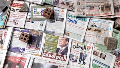 Newspapers laid out at a newsstand Cairo. AFP