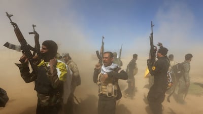 Iraqi fighters of the government-controlled Popular Mobilisation units take part in a military operation to take control of Tikrit on March 11 2015. Ahmad Al Rubaye / AFP