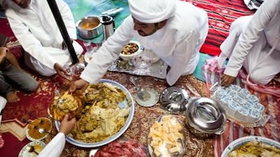 :JuAbdullah Al Yalyle dishes up a traditional meal at his home majlis in Wadi al Tuwa, Ras al Khaimah.