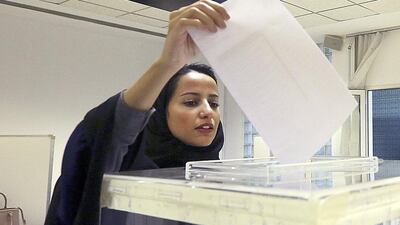 A Saudi woman casts her ballot at a polling center during municipal elections in Riyadh. Aya Batrawy / AP Photo