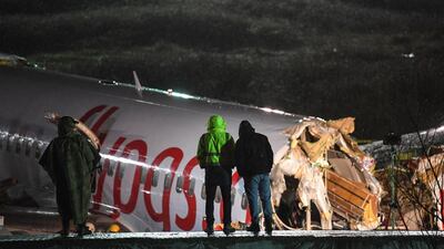 A Turkish soldier stand guard as rescuers work to extract passengers from the crash of a Pegasus Airlines Boeing 737 airplane, after it skidded off the runway upon landing at Sabiha Gokcen airport in Istanbul. AFP