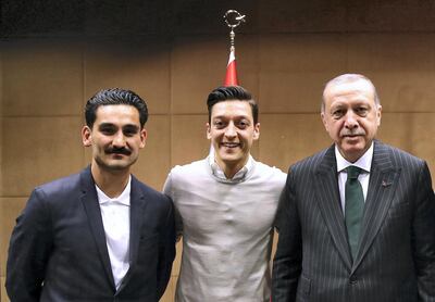 German footballers Mesut Ozil, centre, and Ilkay Gundogan pose with Reccep Tayyip Erdogan during the Turkish president's visit to London. AFP