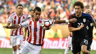 Paraguay’s Derlis Alberto Gonzalez, left, and USA’s Fabian Johnson vie for the ball. Nicholas Kamm / AFP