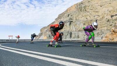 Members of Dubai Longboarding Community showing off their skills at Jabel Jais. Victor Besa for The National.