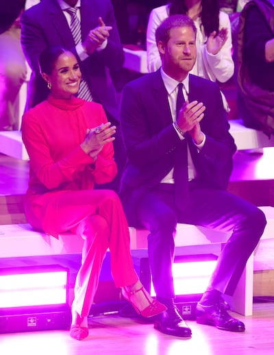 Meghan, Duchess of Sussex, in head-to-toe red, down to her crimson suede pumps. Getty Images