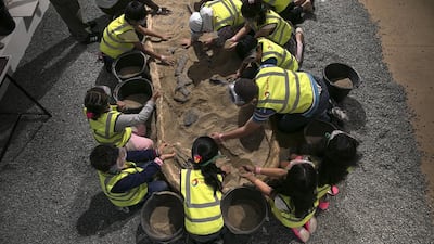 Children uncover a ‘dinosaur’ inside the Dino Dig booth at the Abu Dhabi Science Festival last year. Astronomy groups in Dubai and Abu Dhabi will offer activities such as telescope observations in the evenings. Silvia Razgova / The National
