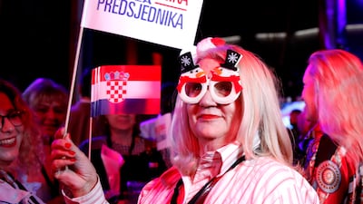 Supporters of Mr Milanovic react to the first results of the country's presidential election. EPA