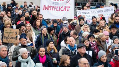 A demonstrator holds a placard reading 'No to compulsory vaccination' during an anti-vaccination protest at the Ballhausplatz square in Austria's capital city of Vienna. AFP