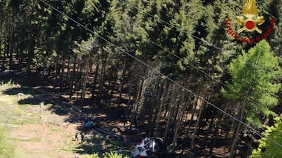 Debris from the cable car is strewn on the ground. AP