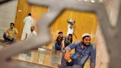 Men on the door step of a mosque in Naif by Hilary Cumberworth. Courtesy Frying Pan Adventures and Gulf Photo Plus