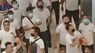 A mob of men in white shirts are threatening pro-democracy protesters after clashes between the two groups at Yuen Long station. Courtesy of Lam Cheuk Ting / AFP Photo