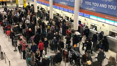 Passengers wait to check in. AP Photo