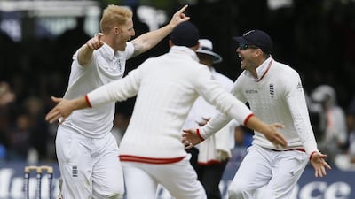 England's Ben Stokes, left, and James Anderson, right, celebrate taking the wicket of New Zealand's captain Brendon McCullum during the fifth day of the first Test match between England and New Zealand at Lord's cricket ground in London, Monday, May 25, 2015. (AP Photo/Kirsty Wigglesworth)
