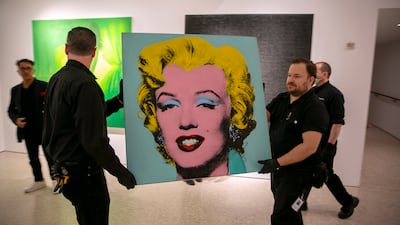 The 1964 painting 'Shot Sage Blue Marilyn' by Andy Warhol is carried in Christie's showroom in New York City, New York. AP