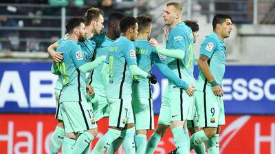 Barcelona players congratulate Lionel Messi after his goal. David Ramos / Getty Images