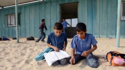 Palestinian pupils at the Al Mawael primary school near Rafah in the southern Gaza Strip. the school, built from old steel containers, is the only one in the area.