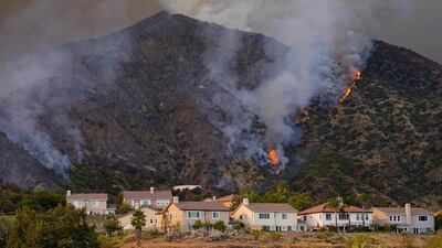 The Ranch Fire burns on a hillside over a residential neighborhood, Thursday, Aug. 13, 2020, in Azusa, California. AP