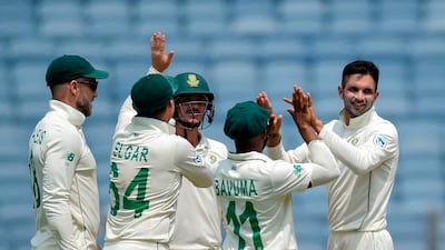 South Africa's Keshav Maharaj, right, celebrates with teammates after dismissing India batsman Ajinkya Rahane. AFP