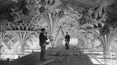 Workmen clean the stonework of the vaulting of Henry VII's Chapel, Westminster Abbey, after the completion of masonry repairs in 1934