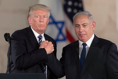 Donald Trump and Benjamin Netanyahu shake hands in Jerusalem in 2017. The two remain close. AP