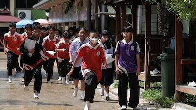 Pupils flee Debsirin Nonthaburi School, on the outskirts of Bangkok, where at least six have been killed in a shooting. Reuters