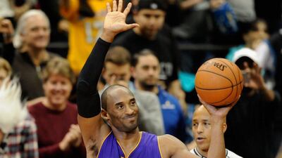 Kobe Bryant of the Lakers waves to the crowd after passing Michael Jordan in the all-time scoring list during his team's NBA win over the Timberwolves on Sunday. Hannah Foslien / Getty Images / AFP / December 14, 2014