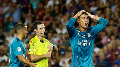 Cristiano Ronaldo, right, reacts after being sent off by referee Ricardo de Burgos. Moments later, Ronaldo shoved Burgos in the back. Manu Fernandez / AP Photo